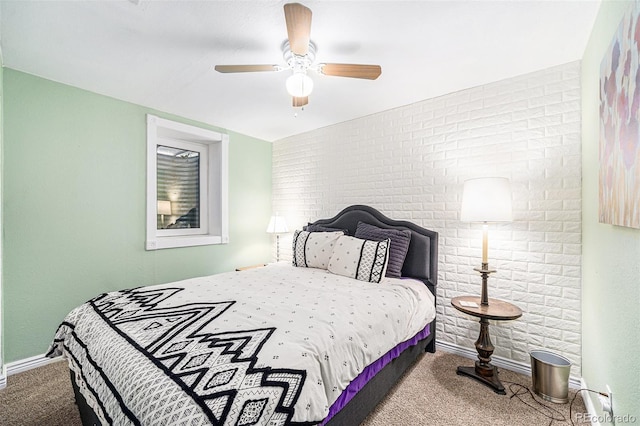 carpeted bedroom featuring ceiling fan and brick wall