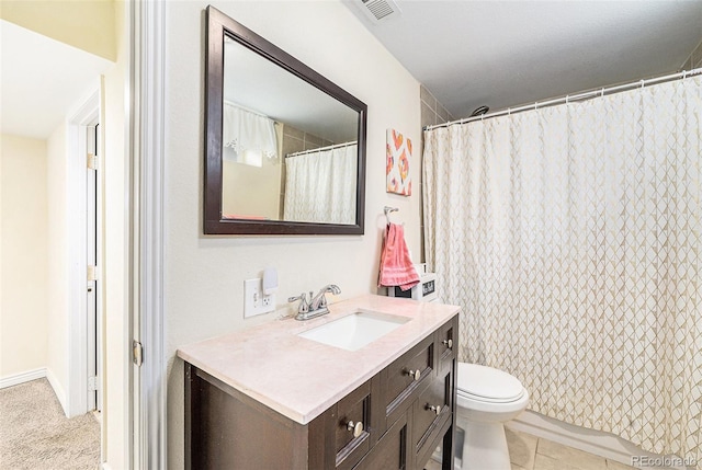 bathroom with tile patterned flooring, vanity, walk in shower, and toilet