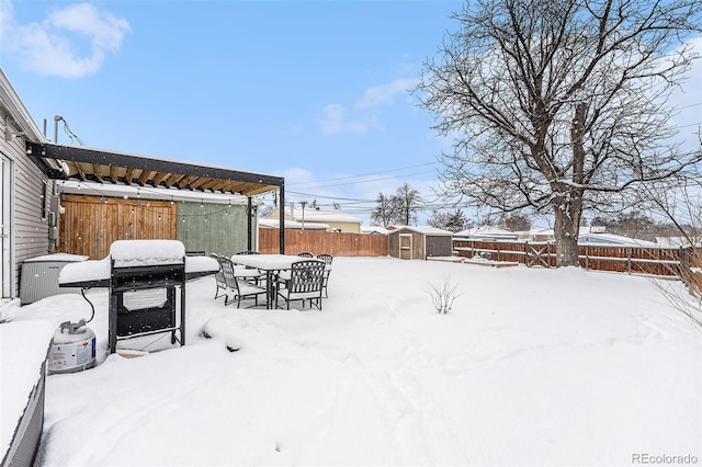 yard layered in snow with a shed