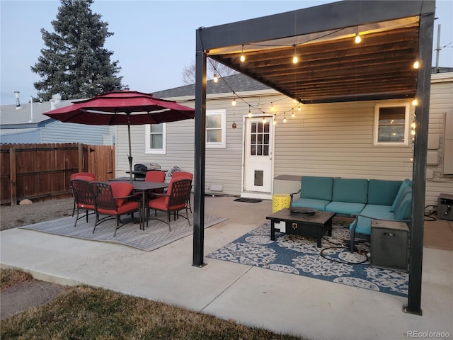 patio terrace at dusk featuring an outdoor hangout area