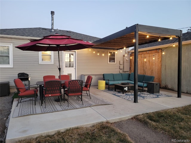 patio terrace at dusk featuring an outdoor hangout area