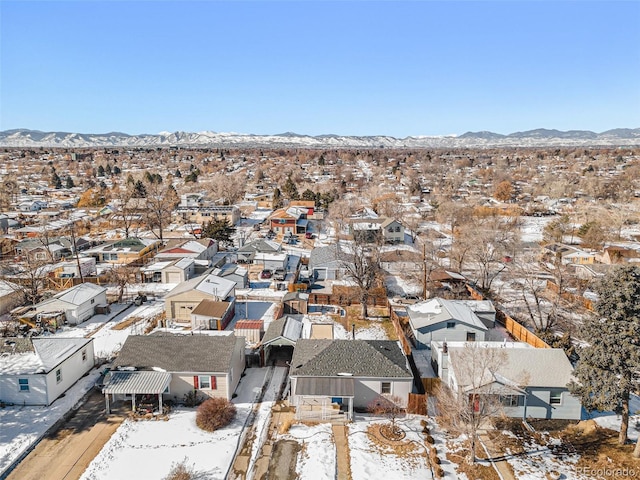 snowy aerial view featuring a mountain view