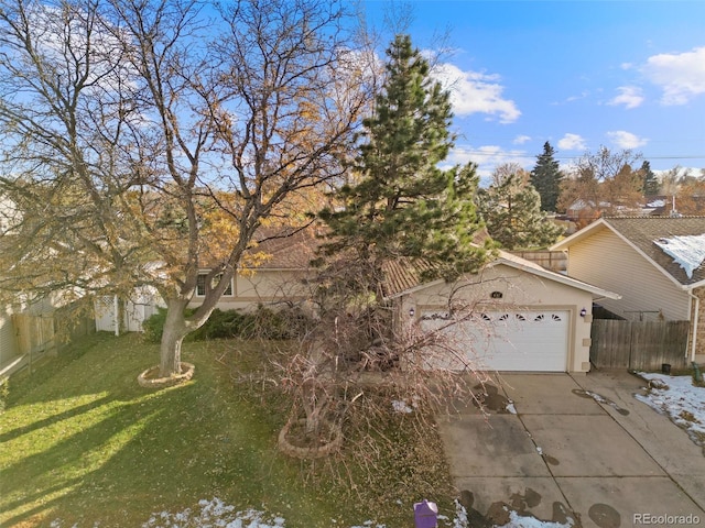 view of front of home featuring a garage and a front lawn