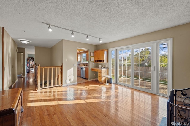 interior space with a textured ceiling and light wood-type flooring