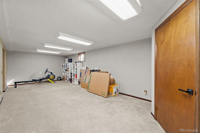 basement featuring light carpet and a textured ceiling