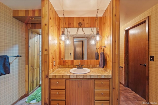 bathroom featuring vanity and wooden walls