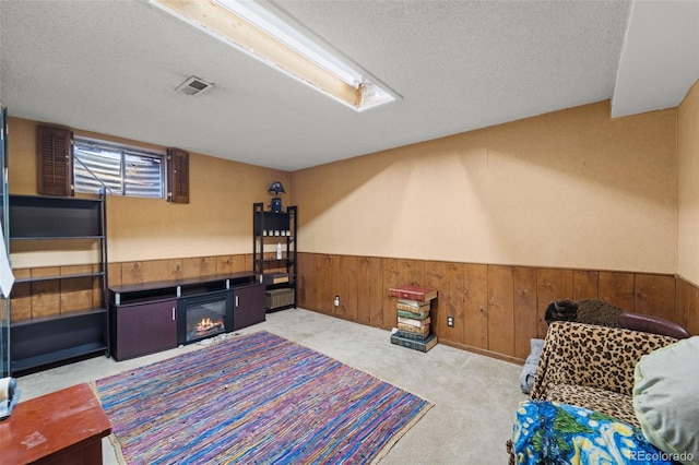 interior space featuring light colored carpet and a textured ceiling