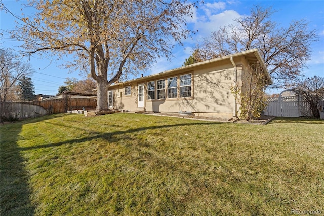 rear view of house with a yard