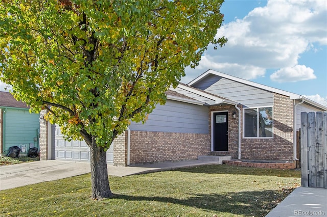 view of property hidden behind natural elements featuring a front yard and a garage