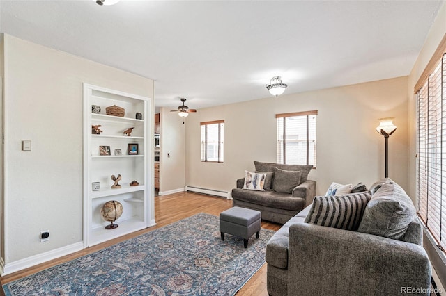 2252 Lamar St, Edgewater, CO 80214 - living room featuring baseboard heating, wood finished floors, baseboards, and a ceiling fan