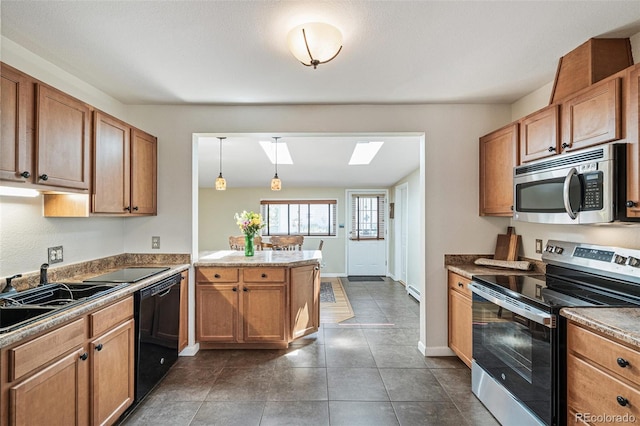 2252 Lamar St, Edgewater, CO 80214 - kitchen featuring stainless steel appliances, a skylight, a sink, a peninsula, and dark tile patterned flooring