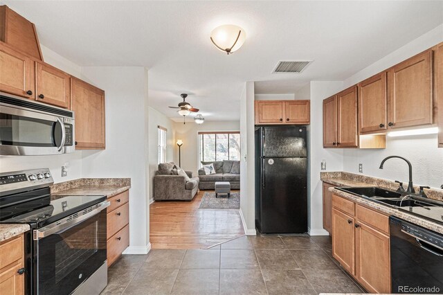 2252 Lamar St, Edgewater, CO 80214 - kitchen with black appliances, a sink, a ceiling fan, baseboards, and open floor plan