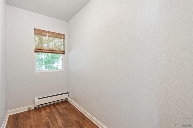 2252 Lamar St, Edgewater, CO 80214 - unfurnished room featuring a baseboard heating unit, baseboards, and dark wood-type flooring