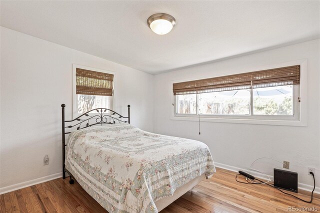 2252 Lamar St, Edgewater, CO 80214 - bedroom featuring baseboards and wood finished floors