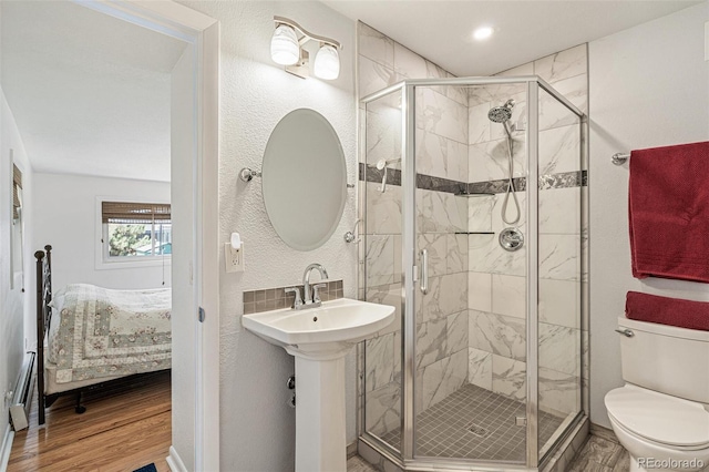 2252 Lamar St, Edgewater, CO 80214 - ensuite bathroom featuring wood finished floors, a shower stall, and toilet