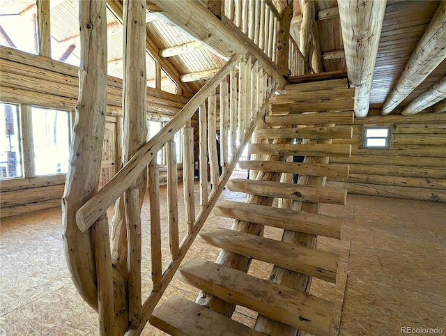 staircase with a towering ceiling