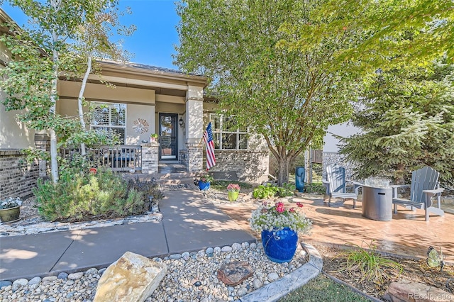 view of front facade with a patio and stucco siding