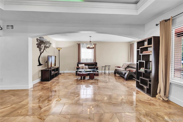 sitting room featuring crown molding and a chandelier