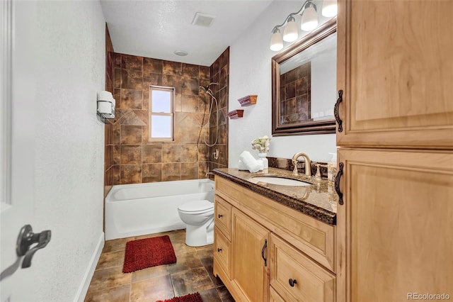 full bathroom featuring vanity, toilet, and tiled shower / bath