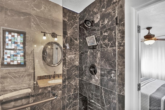 bathroom featuring a textured ceiling, ceiling fan, a wealth of natural light, and a tile shower