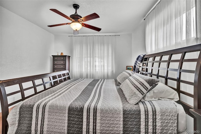 bedroom with multiple windows and ceiling fan