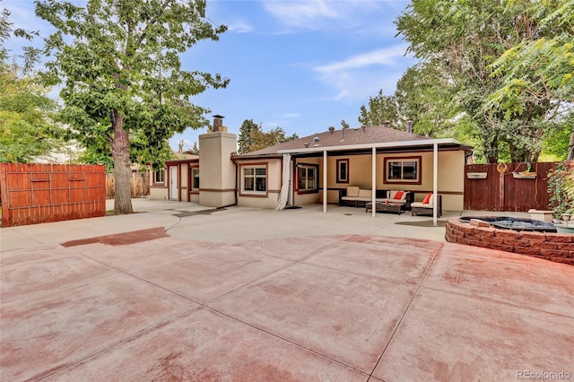 rear view of property with a patio area and an outdoor hangout area