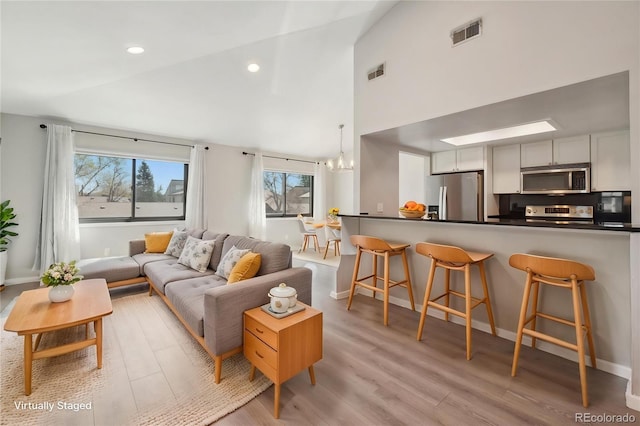 540 S Forest St Unit 3-204, Denver, CO 80246 - living room featuring light wood-style floors, a notable chandelier, recessed lighting, and visible vents