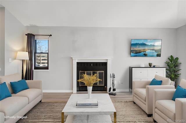 540 S Forest St Unit 3-204, Denver, CO 80246 - living room with baseboards, light wood-style flooring, and a glass covered fireplace