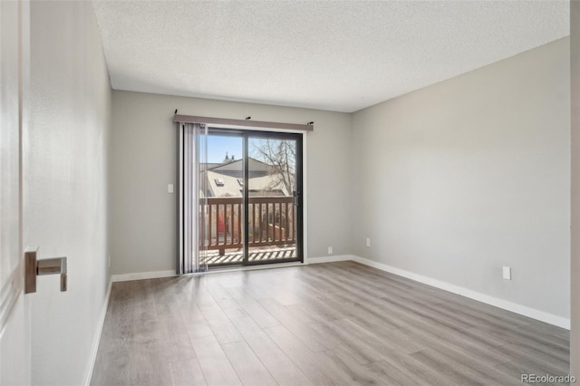 540 S Forest St Unit 3-204, Denver, CO 80246 - empty room featuring baseboards, a textured ceiling, and wood finished floors