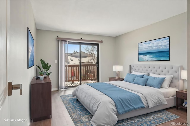 540 S Forest St Unit 3-204, Denver, CO 80246 - bedroom featuring access to exterior and wood finished floors