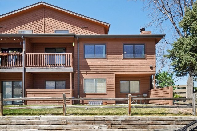 540 S Forest St Unit 3-204, Denver, CO 80246 - back of house with fence, a balcony, and a chimney