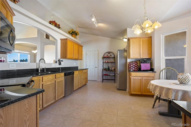 17950 Cumbres Rd, Peyton, CO 80831 - kitchen with vaulted ceiling, stainless steel appliances, a sink, a chandelier, and arched walkways