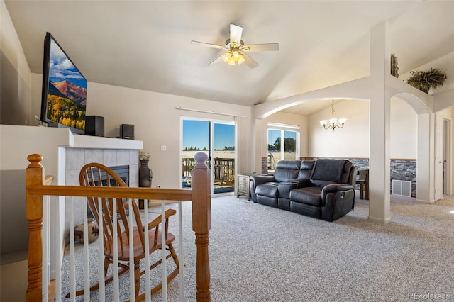 17950 Cumbres Rd, Peyton, CO 80831 - living area featuring carpet, arched walkways, a ceiling fan, lofted ceiling, and a chandelier