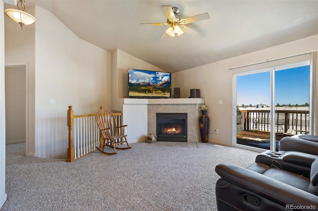 17950 Cumbres Rd, Peyton, CO 80831 - carpeted living area featuring ceiling fan, vaulted ceiling, a tile fireplace, and baseboards