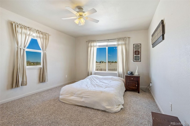 17950 Cumbres Rd, Peyton, CO 80831 - carpeted bedroom featuring multiple windows, baseboards, and a ceiling fan