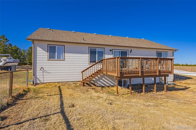 17950 Cumbres Rd, Peyton, CO 80831 - rear view of property featuring fence, a deck, and a shingled roof