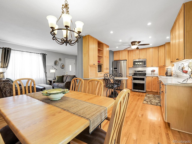 6810 S Marion Cir W, Centennial, CO 80122 - dining room featuring a ceiling fan, a chandelier, recessed lighting, and light wood-style floors