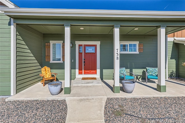 view of exterior entry with covered porch