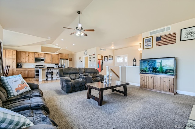 living room with ceiling fan, vaulted ceiling, and carpet flooring