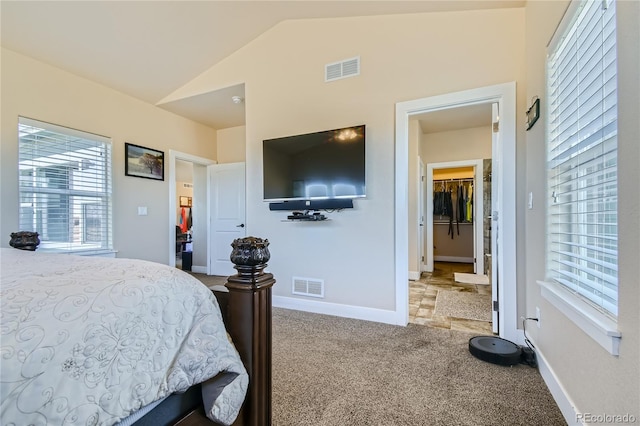 bedroom featuring light carpet, a closet, and vaulted ceiling