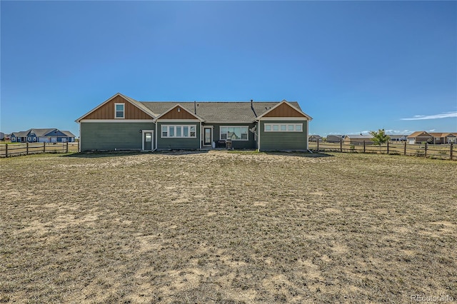 view of front of house with a front yard and a patio area