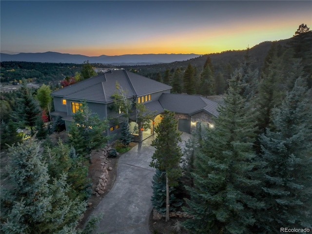 aerial view at dusk featuring a mountain view