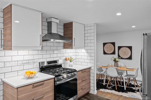 4100 Shaw Blvd, Westminster, CO 80031 - kitchen featuring wall chimney exhaust hood, stainless steel appliances, modern cabinets, dark wood-style floors, and decorative backsplash