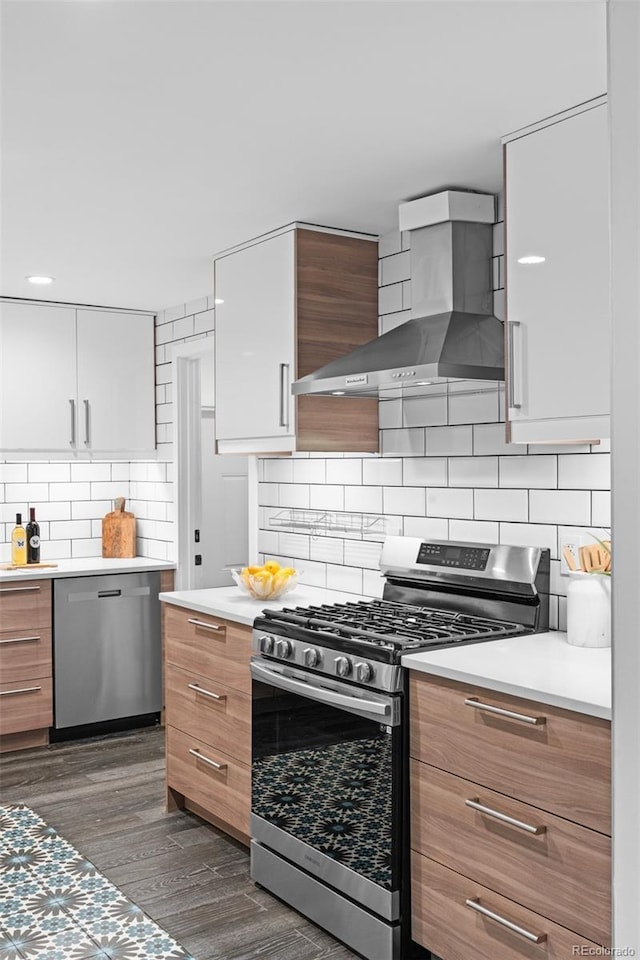 4100 Shaw Blvd, Westminster, CO 80031 - kitchen with appliances with stainless steel finishes, wall chimney exhaust hood, dark wood-style floors, light countertops, and decorative backsplash