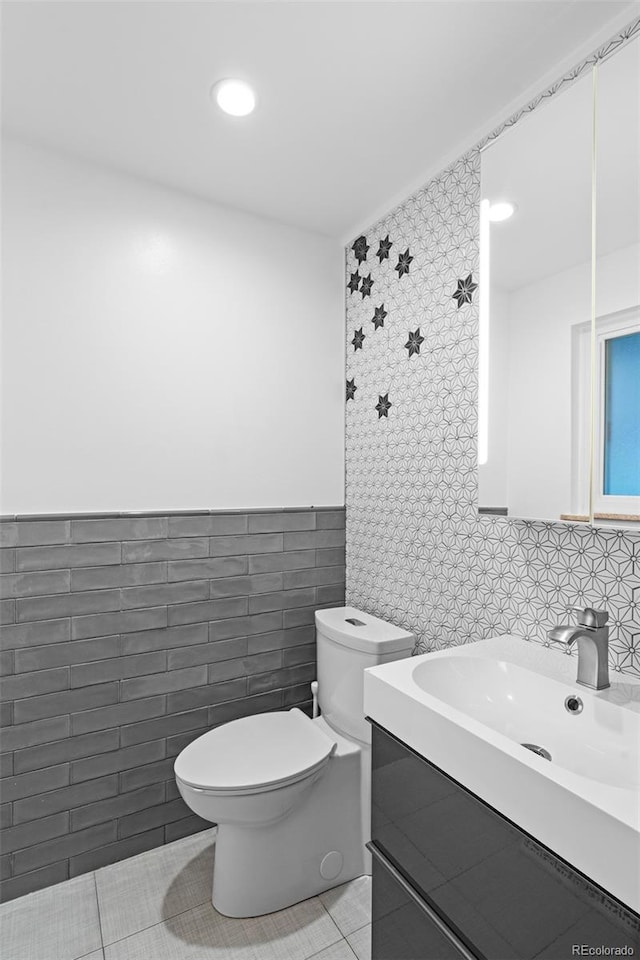 4100 Shaw Blvd, Westminster, CO 80031 - half bathroom featuring tile walls, vanity, tile patterned flooring, recessed lighting, and wainscoting