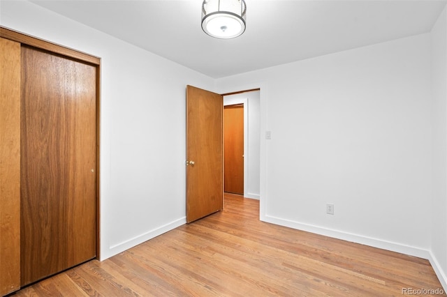 4100 Shaw Blvd, Westminster, CO 80031 - unfurnished bedroom featuring a closet and wood finished floors