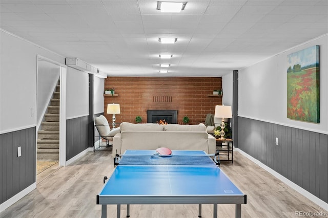 4100 Shaw Blvd, Westminster, CO 80031 - playroom with wood finished floors, a warm lit fireplace, a wainscoted wall, and wooden walls
