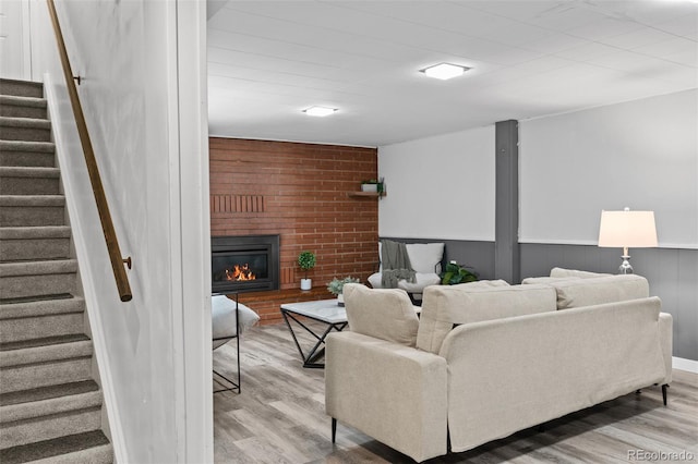 4100 Shaw Blvd, Westminster, CO 80031 - living area with wood finished floors, stairs, and a brick fireplace