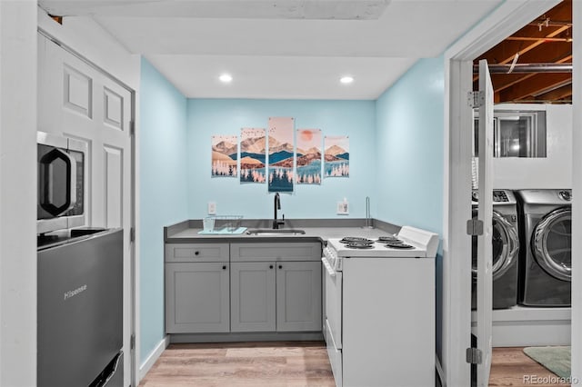 4100 Shaw Blvd, Westminster, CO 80031 - laundry room featuring independent washer and dryer, light wood-type flooring, bar with sink, and recessed lighting