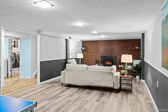 4100 Shaw Blvd, Westminster, CO 80031 - living room with washer and dryer, wood finished floors, a fireplace, and wainscoting